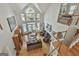 Open living room boasting natural light, high ceilings, fireplace, and staircase at 1000 Pleasance Grv, Peachtree City, GA 30269