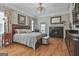 Cozy main bedroom with hardwood floors, a fireplace, and a plush bed at 1000 Pleasance Grv, Peachtree City, GA 30269
