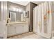 Neutral bathroom featuring large mirror and vanity, updated lighting, and shower/tub combo at 606 Ridgelake Dr, Peachtree City, GA 30269