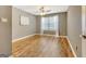 Bedroom offering hardwood floors, neutral paint, ceiling fan, and bright window at 606 Ridgelake Dr, Peachtree City, GA 30269