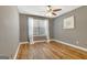 Empty bedroom featuring a ceiling fan, new hardwood floors, fresh paint and bright window at 606 Ridgelake Dr, Peachtree City, GA 30269