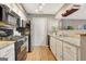 Updated kitchen featuring granite counters, black appliances, wood floors, and white cabinets at 606 Ridgelake Dr, Peachtree City, GA 30269