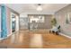 Open-concept living room with hardwood floors, view of the kitchen and access to the patio at 606 Ridgelake Dr, Peachtree City, GA 30269