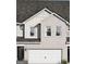 Charming two-story home features a gray roof, brick facade, and an attached two-car garage at 2272 Santa Fe St # 21, Morrow, GA 30260