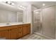 Bright bathroom with dual sinks, a large mirror, modern lighting and a glass-enclosed shower at 823 Mackay Crk, Woodstock, GA 30188