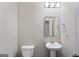 Simple bathroom featuring a pedestal sink, toilet, square framed mirror, and modern lighting at 823 Mackay Crk, Woodstock, GA 30188