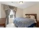 Bedroom with a bed dressed in blue patterned bedding, curtains, and a wooden dresser at 823 Mackay Crk, Woodstock, GA 30188