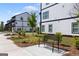 A bench sits on a landscaped walkway next to new townhomes at 823 Mackay Crk, Woodstock, GA 30188