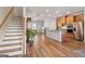 A view of the kitchen with wood cabinets, granite countertops, and stainless steel appliances open to living area at 823 Mackay Crk, Woodstock, GA 30188