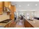 A view of the kitchen with wood cabinets, granite countertops, and stainless steel appliances at 823 Mackay Crk, Woodstock, GA 30188
