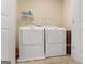 Convenient laundry area with washer, dryer, and shelving for storage at 823 Mackay Crk, Woodstock, GA 30188