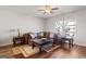 A view of the living room with hardwood floors, a dark brown couch, and ornate coffee tables at 823 Mackay Crk, Woodstock, GA 30188