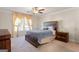 Comfortable main bedroom featuring a ceiling fan, carpet, and natural light from the window at 823 Mackay Crk, Woodstock, GA 30188
