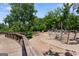 Fun playground area with climbing structures and a wooden bridge surrounded by lush greenery at 823 Mackay Crk, Woodstock, GA 30188