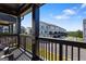 A view from the back porch with a railing, a street, and new construction townhomes in the distance at 823 Mackay Crk, Woodstock, GA 30188