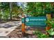 Greenprints trail sign surrounded by lush greenery, inviting outdoor adventures at 823 Mackay Crk, Woodstock, GA 30188
