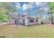 View of the back of the house showing a covered back porch and large windows at 916 Forest Pointe, Jonesboro, GA 30238