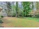 Large backyard with lush greenery and mature trees, providing a private and serene outdoor space at 916 Forest Pointe, Jonesboro, GA 30238