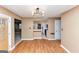 Dining area with modern lighting, wooden floors, and an open layout connecting to the kitchen at 916 Forest Pointe, Jonesboro, GA 30238