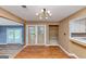 Dining area with modern lighting, wooden floors, and views into other rooms at 916 Forest Pointe, Jonesboro, GA 30238