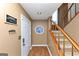 Inviting entryway with wood floors, a decorative stained-glass window, and a convenient staircase at 916 Forest Pointe, Jonesboro, GA 30238