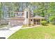 Charming two-story home with a unique turret and an attached two-car garage nestled among mature trees at 916 Forest Pointe, Jonesboro, GA 30238