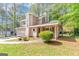 Charming two-story home with a unique turret and an attached two-car garage nestled among mature trees at 916 Forest Pointe, Jonesboro, GA 30238