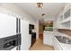 Kitchen featuring white cabinetry, black appliances, and stainless steel sink at 916 Forest Pointe, Jonesboro, GA 30238