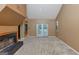 Spacious living room featuring a fireplace, neutral carpet, and glass doors to the outside at 916 Forest Pointe, Jonesboro, GA 30238