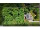 An overhead shot displaying a home with a beautiful backyard, backing into a wooded area at 115 Blue Grass Way, Oxford, GA 30054