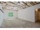 Unfinished basement room featuring carpet floors and a window at 115 Blue Grass Way, Oxford, GA 30054