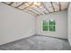Bedroom in unfinished basement with carpet flooring and natural light at 115 Blue Grass Way, Oxford, GA 30054