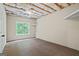 Unfinished basement area featuring a large window, offering natural light and a view of the outdoors at 115 Blue Grass Way, Oxford, GA 30054