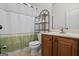 A well-lit bathroom showcasing a shower and a wooden vanity at 115 Blue Grass Way, Oxford, GA 30054