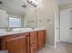 Bathroom featuring a double vanity with wood cabinets, a large mirror, and tiled flooring at 115 Blue Grass Way, Oxford, GA 30054