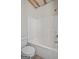 Bathroom featuring a bathtub and shower combination with white tile surround and flooring at 115 Blue Grass Way, Oxford, GA 30054