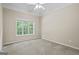 Neutral bedroom with carpet and a window at 115 Blue Grass Way, Oxford, GA 30054