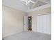 Spacious bedroom with vaulted ceiling, carpet flooring, closet, and fan at 115 Blue Grass Way, Oxford, GA 30054