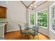 Bright breakfast nook featuring a glass table, chairs, and natural light streaming through windows at 115 Blue Grass Way, Oxford, GA 30054