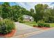 Attractive home with a long driveway and well-maintained landscaping, set back from the road with mature trees at 115 Blue Grass Way, Oxford, GA 30054