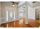Grand foyer with hardwood floors, decorative pillars and trim, and a stylish front door at 115 Blue Grass Way, Oxford, GA 30054