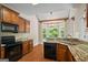 Beautiful kitchen with granite countertops, stainless steel appliances, and a bay window at 115 Blue Grass Way, Oxford, GA 30054