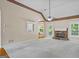 Bright living room with a stone fireplace, ceiling fan, and views to the back yard at 115 Blue Grass Way, Oxford, GA 30054
