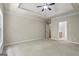 Large carpeted main bedroom with tray ceiling and en-suite bathroom access at 115 Blue Grass Way, Oxford, GA 30054