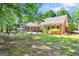 Expansive backyard with brick home, patio area, and mature trees at 401 Riverwalk, Mcdonough, GA 30252