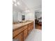 Bathroom featuring double sinks with granite countertops, full mirror and wood cabinets at 401 Riverwalk, Mcdonough, GA 30252