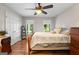 Bedroom features hardwood floors, ceiling fan, and large windows at 401 Riverwalk, Mcdonough, GA 30252