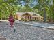 Beautifully landscaped home featuring a circular driveway and mature trees at 401 Riverwalk, Mcdonough, GA 30252
