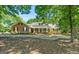 Charming brick home with a welcoming front porch and lush landscaping at 401 Riverwalk, Mcdonough, GA 30252