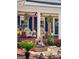 Close-up of cozy front porch with seating, a fountain, and greenery at 401 Riverwalk, Mcdonough, GA 30252